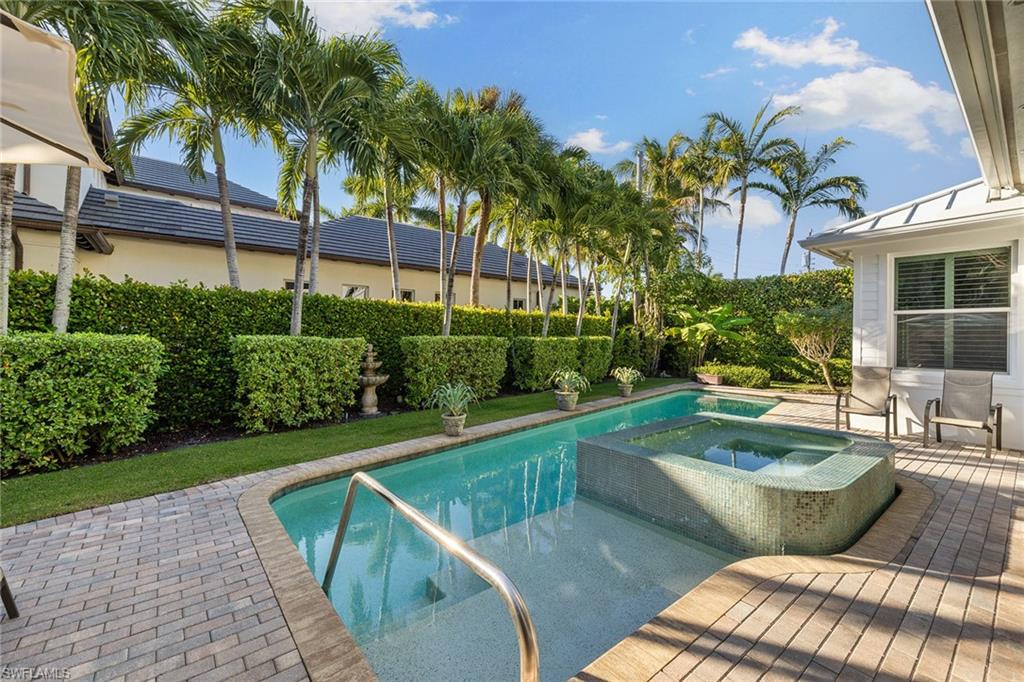 642 Bougainvillea Road Naples, FL 34102 - Photo 45 of 50 View of pool featuring a patio area and a pool with connected hot tub