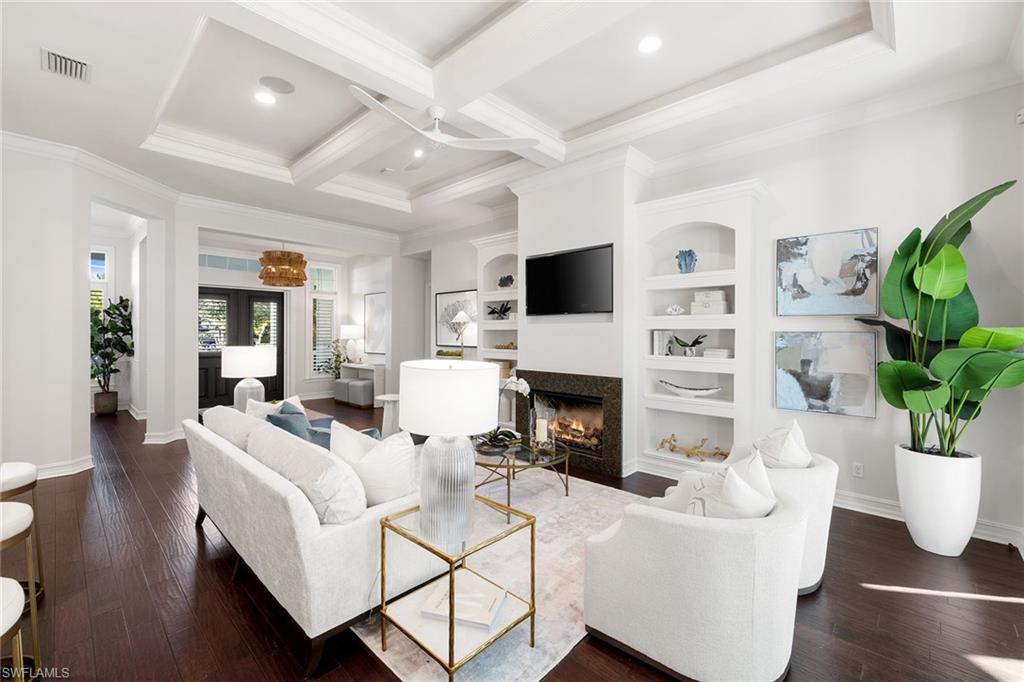 642 Bougainvillea Road Naples, FL 34102 - Photo 9 of 50 Living area featuring coffered ceiling, a premium fireplace, beamed ceiling, ornamental molding, and dark wood-style floors