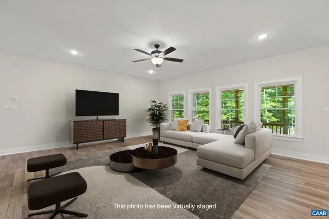 a kitchen with stainless steel appliances granite countertop a sink a stove a refrigerator and white cabinets