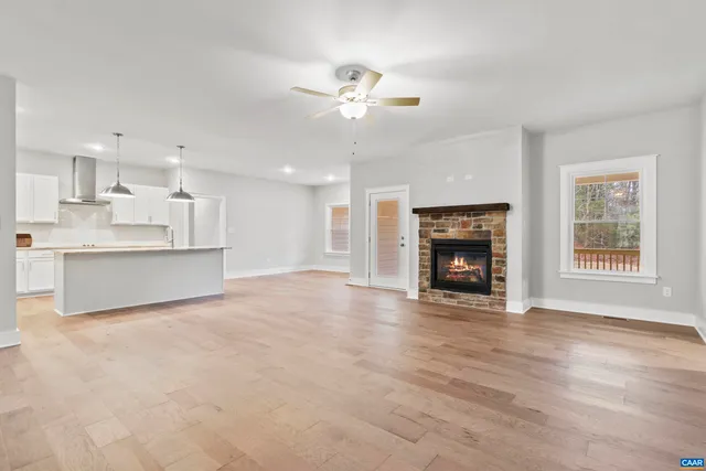 a view of an empty room with a fireplace and a window