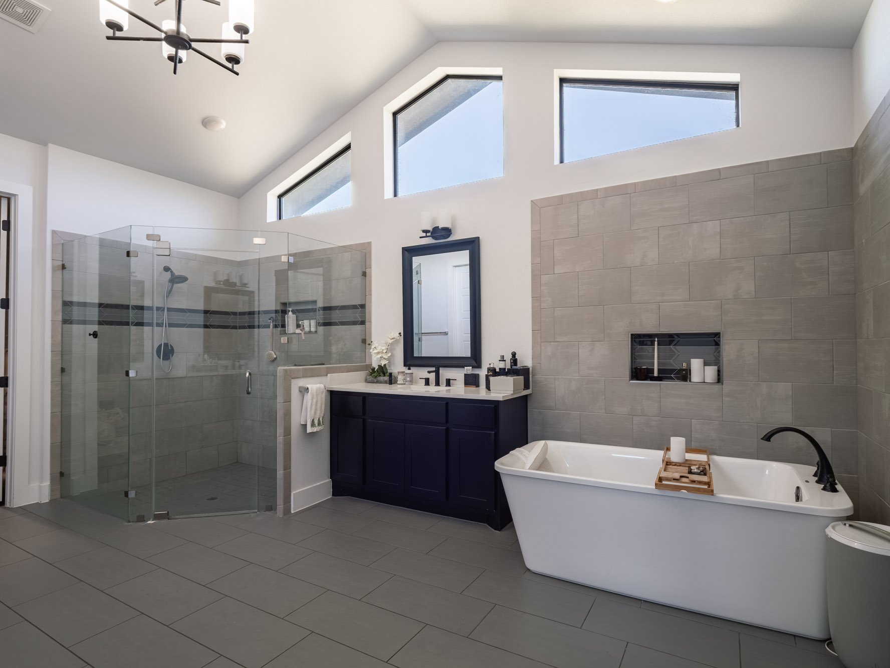 14900 Copper Ridge Lane Austin, TX 78734 - Photo 22 of 39 Full bathroom with a freestanding bath, vanity, a stall shower, light tile patterned flooring, and a chandelier