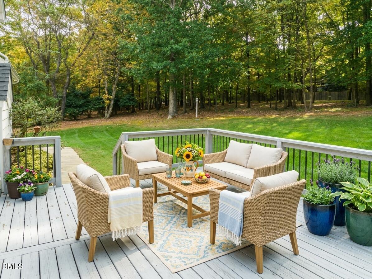 1009 Hidden River Court Raleigh, NC 27614 - Photo 13 of 40 a view of a patio with couches chairs and a yard
