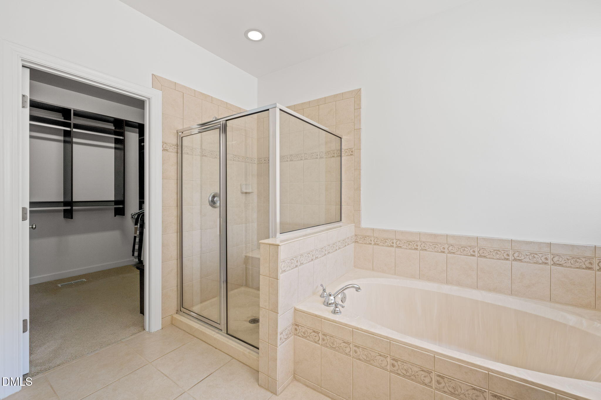 1009 Hidden River Court Raleigh, NC 27614 - Photo 17 of 40 a bathroom with a bathtub and a shower