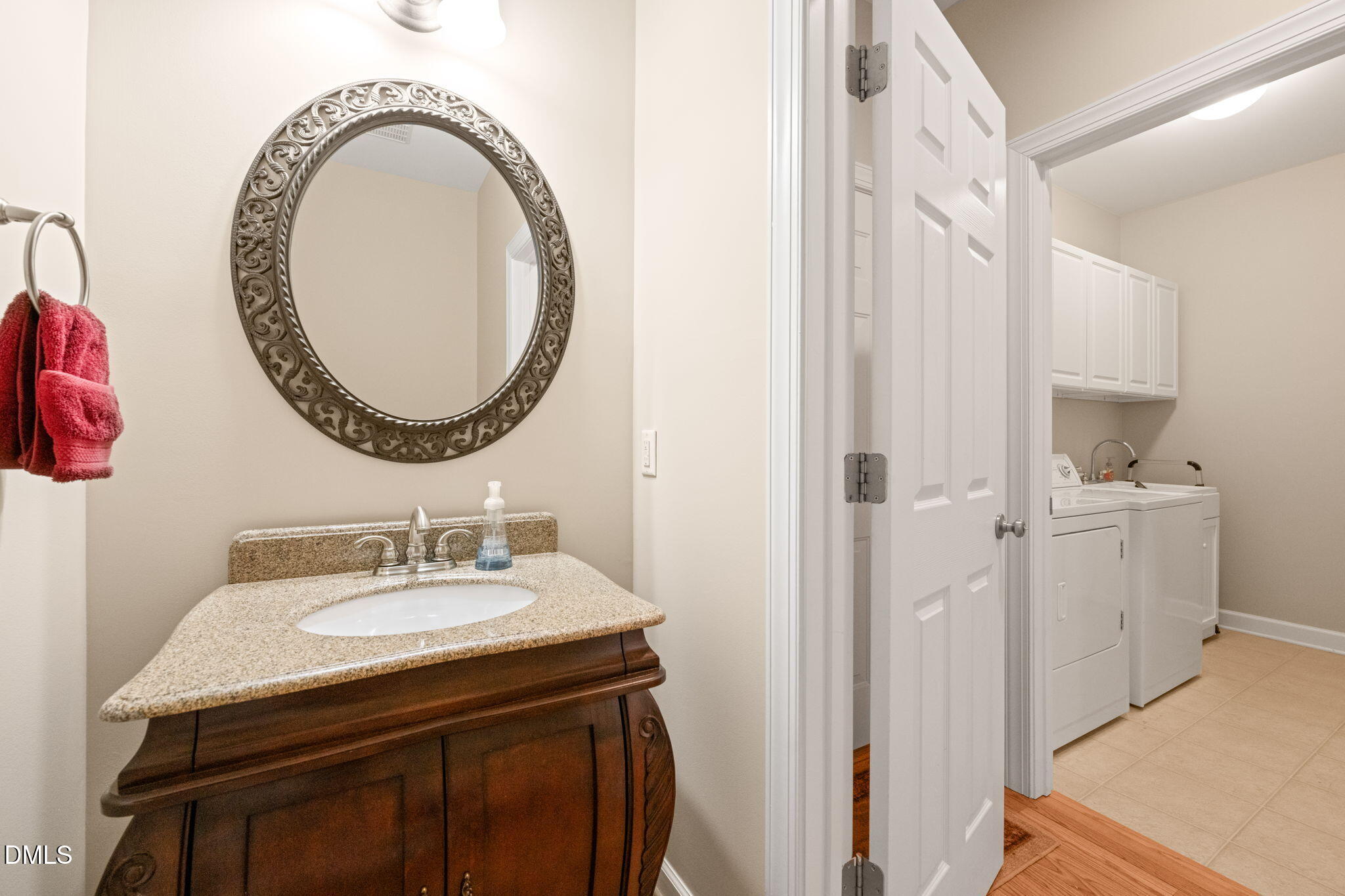 1009 Hidden River Court Raleigh, NC 27614 - Photo 20 of 40 a bathroom with a sink a mirror and a toilet