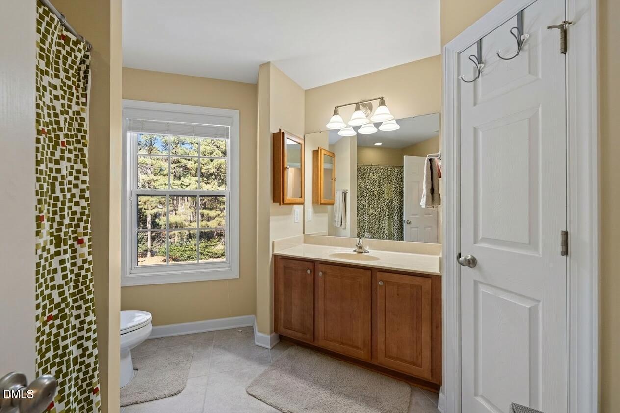 1009 Hidden River Court Raleigh, NC 27614 - Photo 24 of 40 a bathroom with a double vanity sink mirror and next to a window