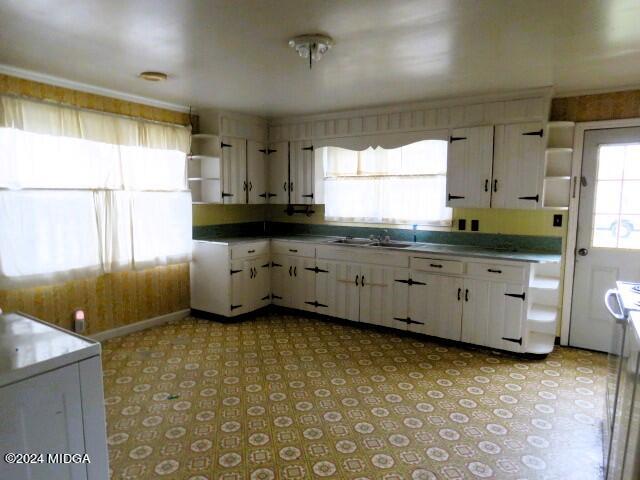 7367 Columbus Road Lizella, GA 31052 - Photo 3 of 12 a kitchen with granite countertop a sink a stove a counter space and cabinets