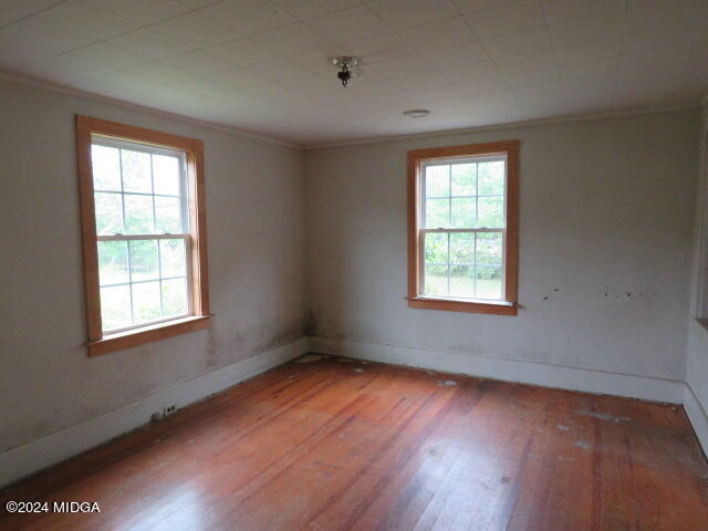 7367 Columbus Road Lizella, GA 31052 - Photo 10 of 12 a view of an empty room with wooden floor and a window