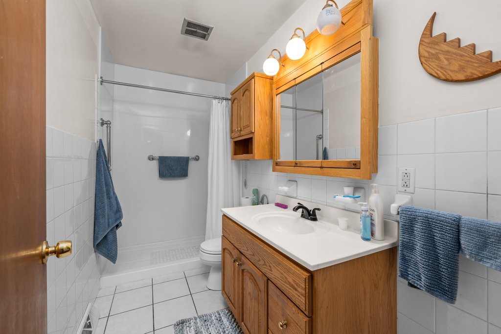 11213 22nd Street Milan, IL 61264 - Photo 6 of 36 a bathroom with a sink and a mirror