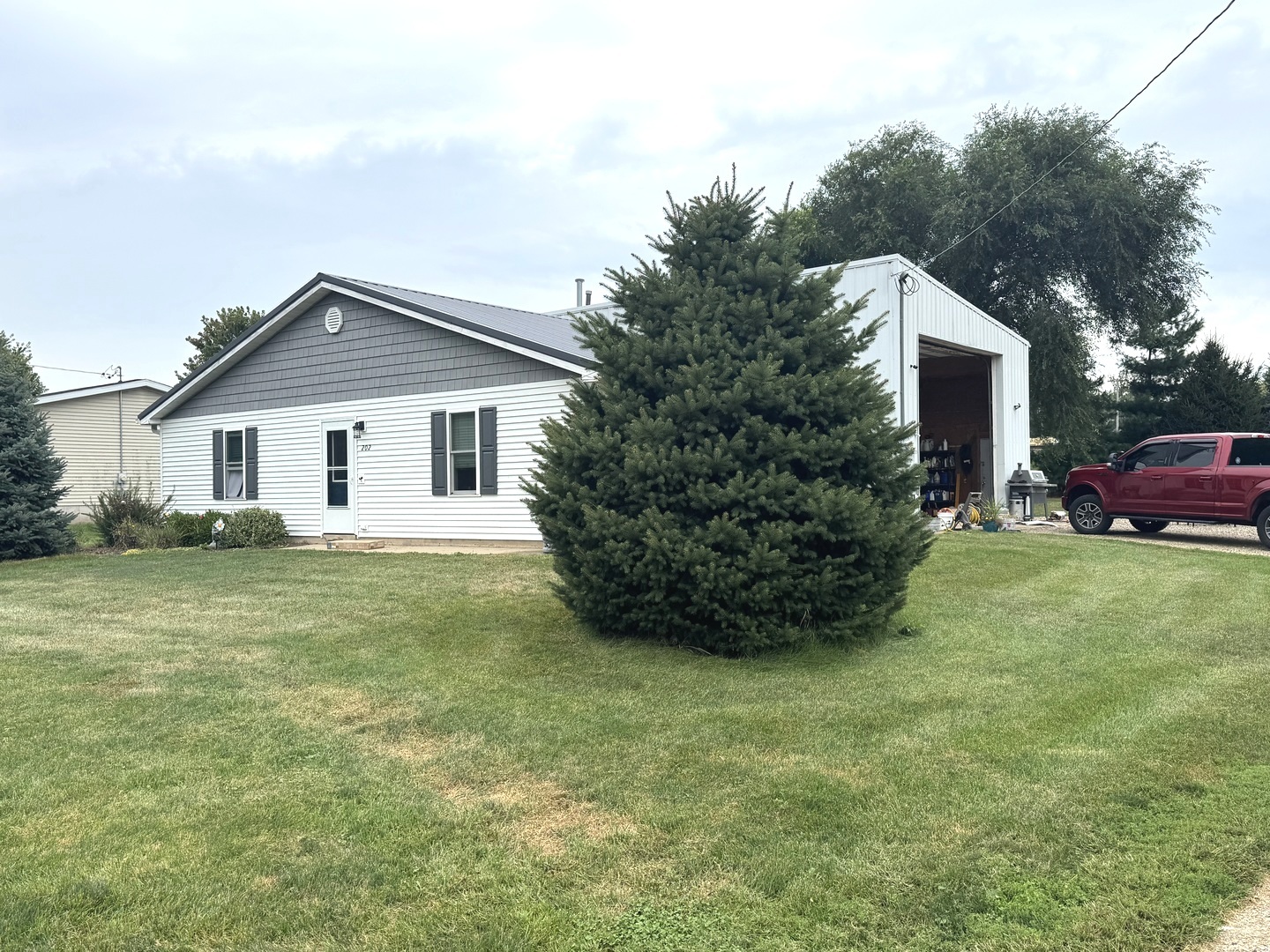 a front view of house with yard and green space