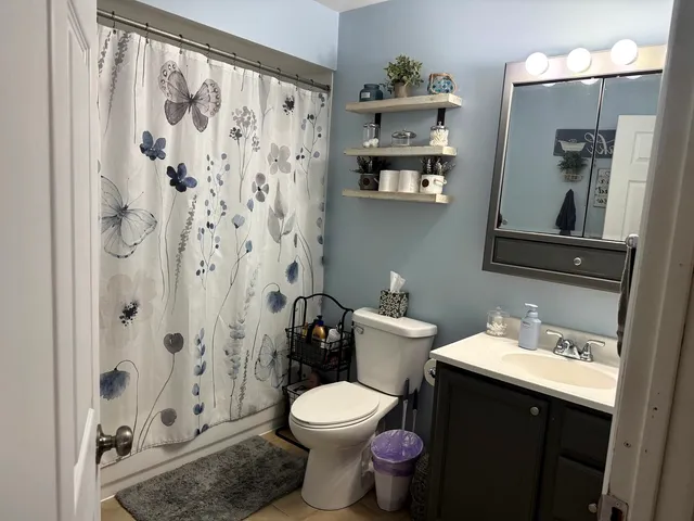 a bathroom with a toilet sink and shower