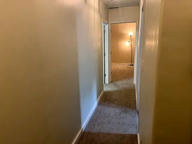 a view of a bathroom from a hallway