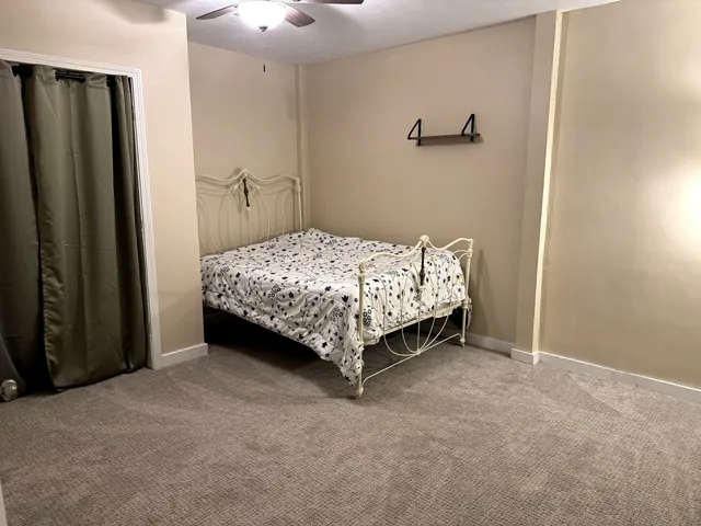 a bed sitting in a bedroom next to a bathroom