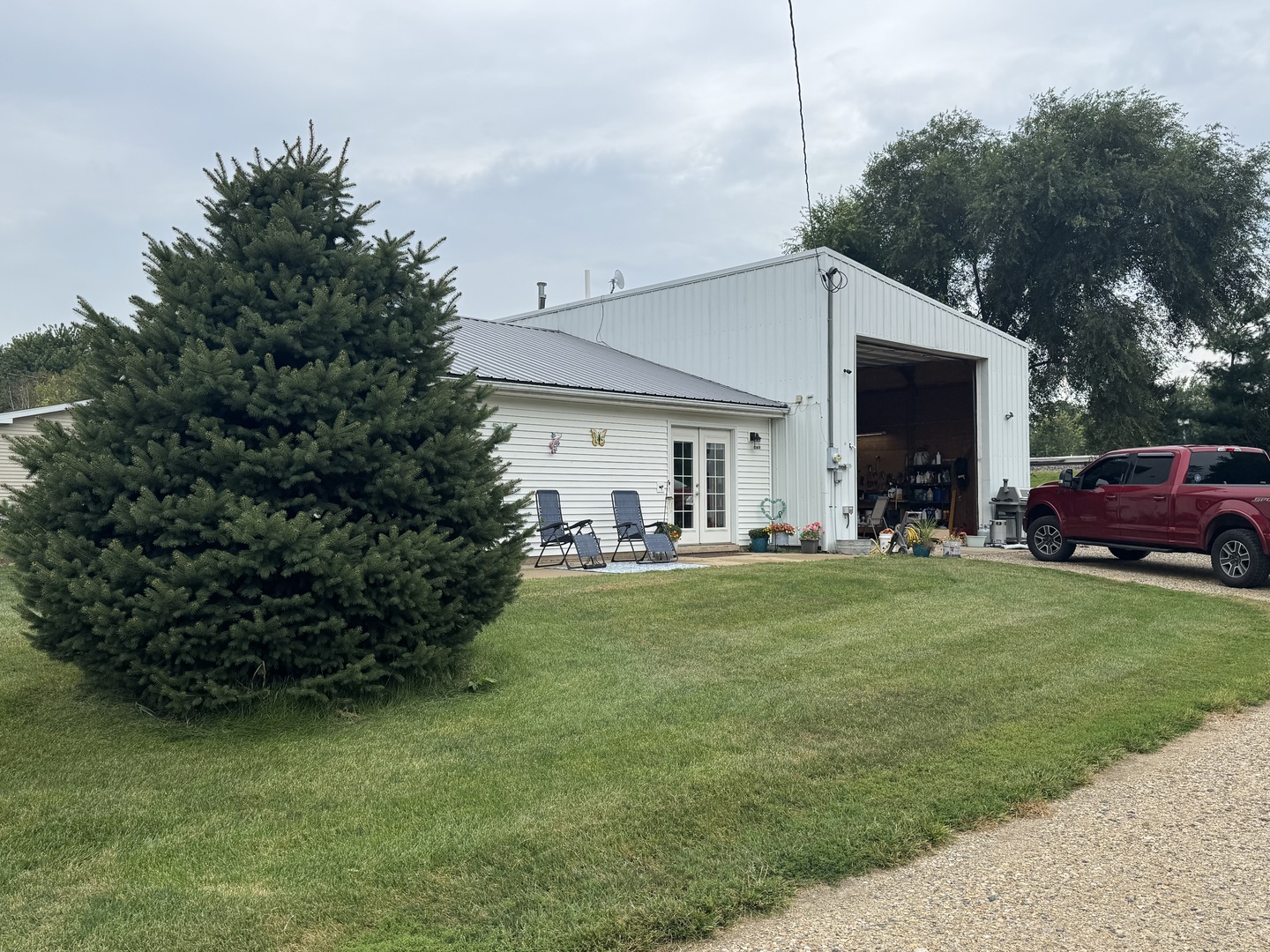 202 Front Street Malden, IL 61337 - Photo 2 of 17 a front view of a house with garden