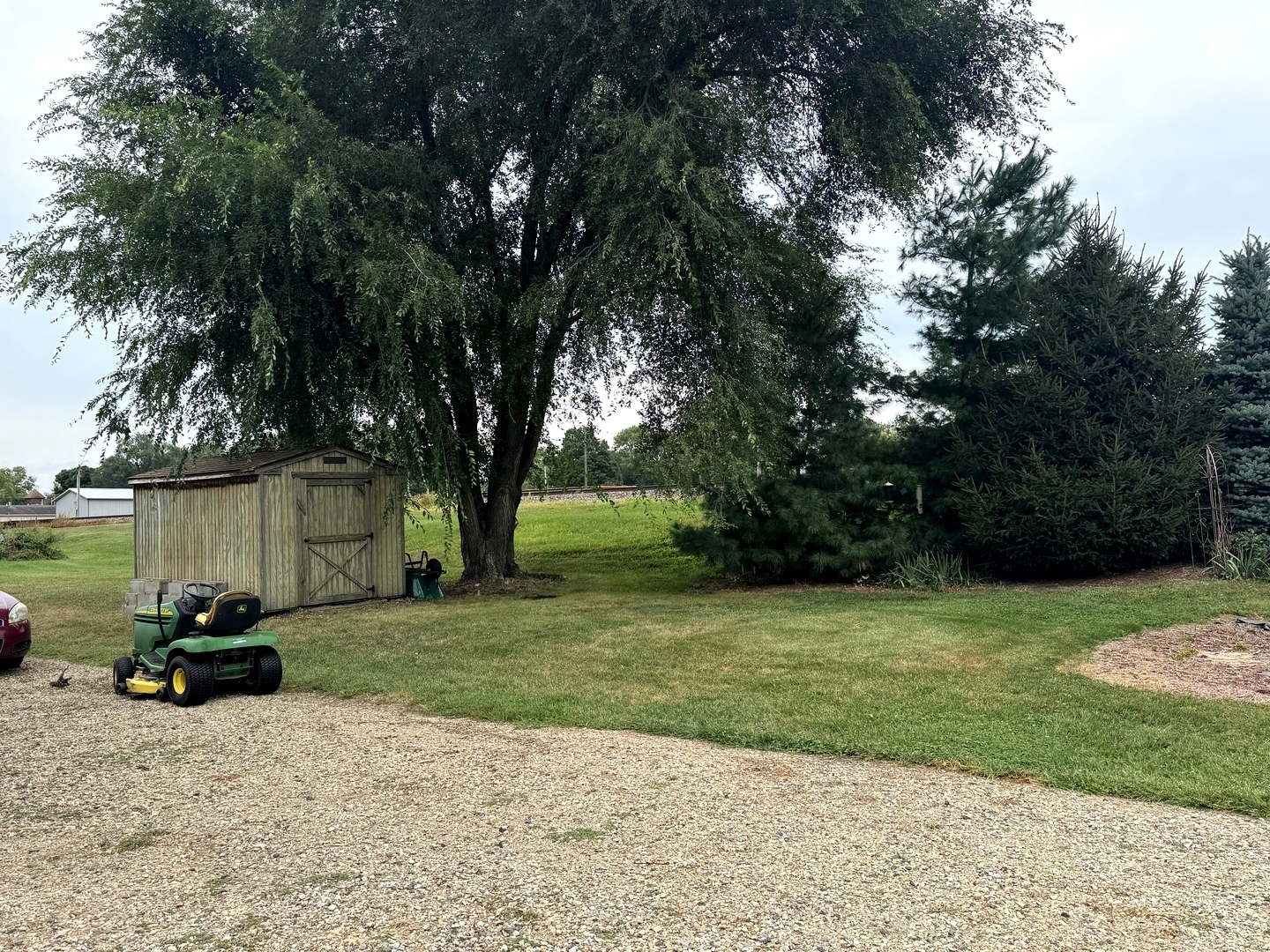202 Front Street Malden, IL 61337 - Photo 4 of 17 a backyard of a house with lots of green space and fountain