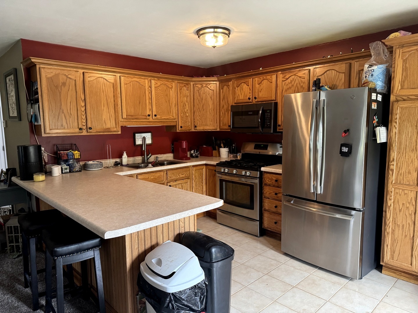 202 Front Street Malden, IL 61337 - Photo 6 of 17 a kitchen with stainless steel appliances granite countertop a refrigerator a stove a sink and a refrigerator
