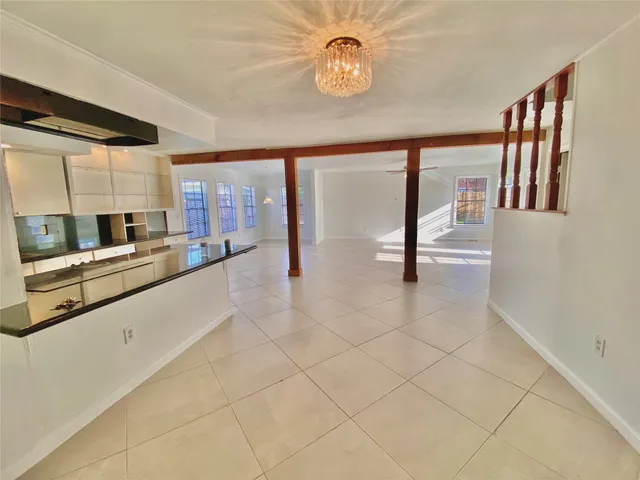 a large kitchen with kitchen island granite countertop a stove a sink and a granite counter top