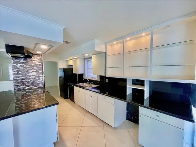a view of a hallway with wooden floor and a living room