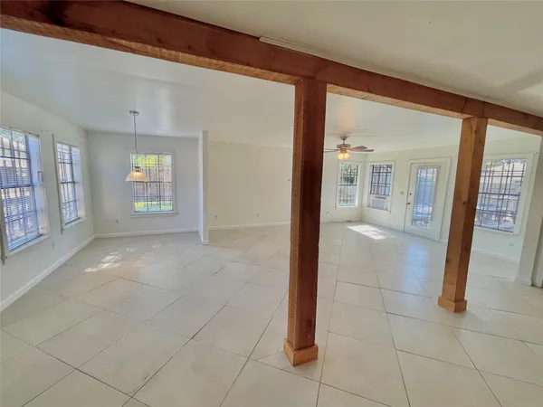 a view of a livingroom with a ceiling fan and window
