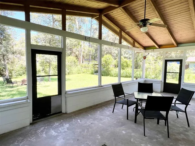 a view of a dining room with furniture a chandelier and wooden floor