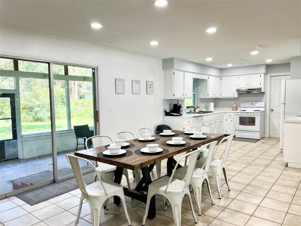 2240 Northwest 14th Avenue Gainesville, FL 32605 - Photo 3 of 13 a view of a dining room with furniture window and outside view
