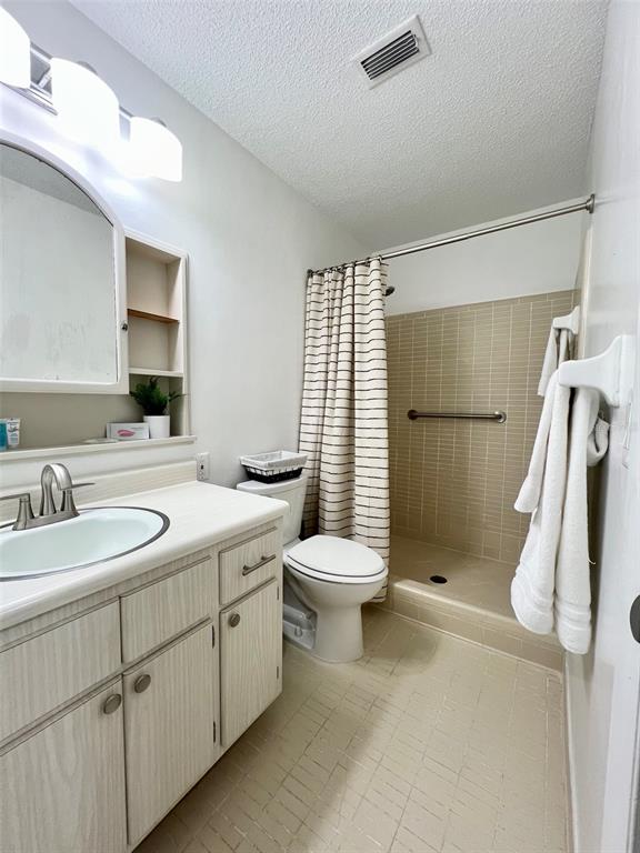 2240 Northwest 14th Avenue Gainesville, FL 32605 - Photo 5 of 13 a bathroom with a sink toilet and shower