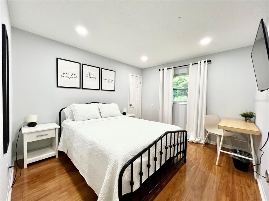 2240 Northwest 14th Avenue Gainesville, FL 32605 - Photo 9 of 13 a bedroom with a bed and a window