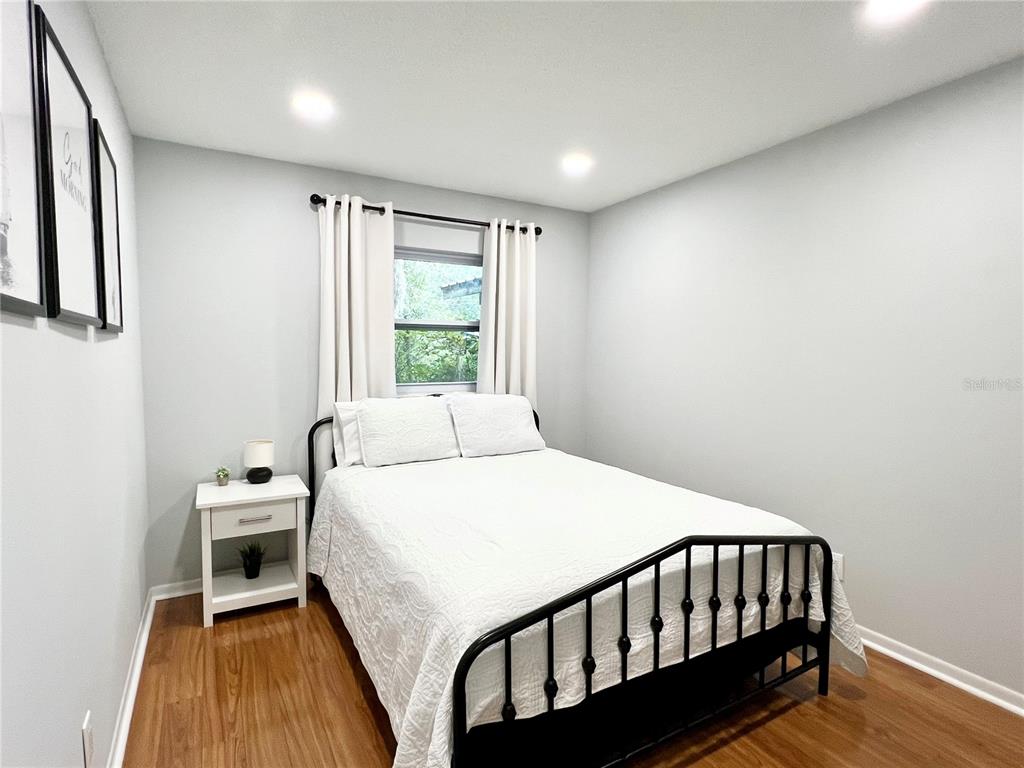 2240 Northwest 14th Avenue Gainesville, FL 32605 - Photo 10 of 13 a bedroom with a bed and a window