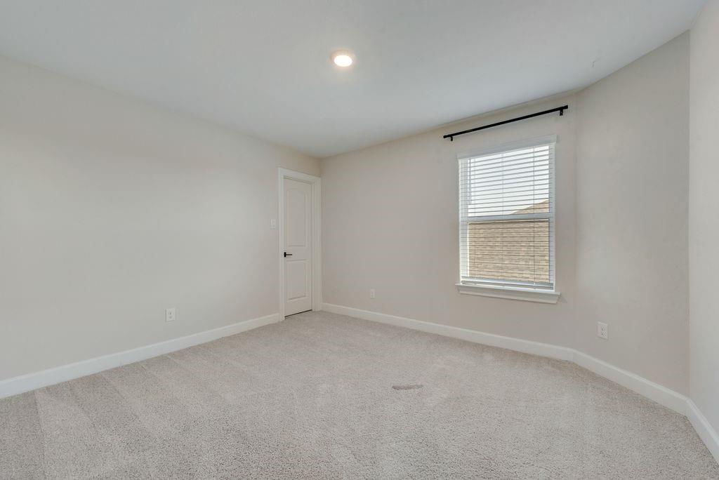 1421 Butler Avenue Princeton, TX 75407 - Photo 14 of 25 an empty room with a window