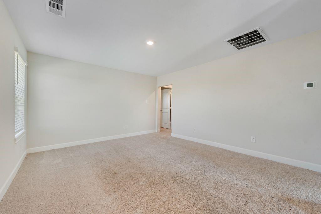 1421 Butler Avenue Princeton, TX 75407 - Photo 17 of 25 an empty room with windows