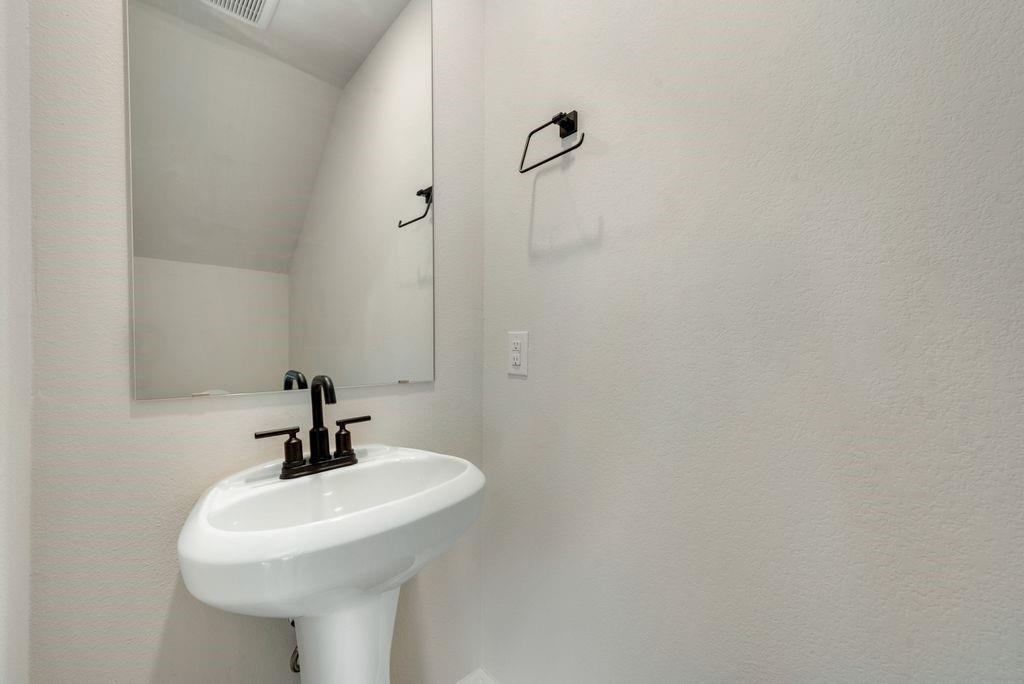 1421 Butler Avenue Princeton, TX 75407 - Photo 22 of 25 a bathroom with a sink and mirror