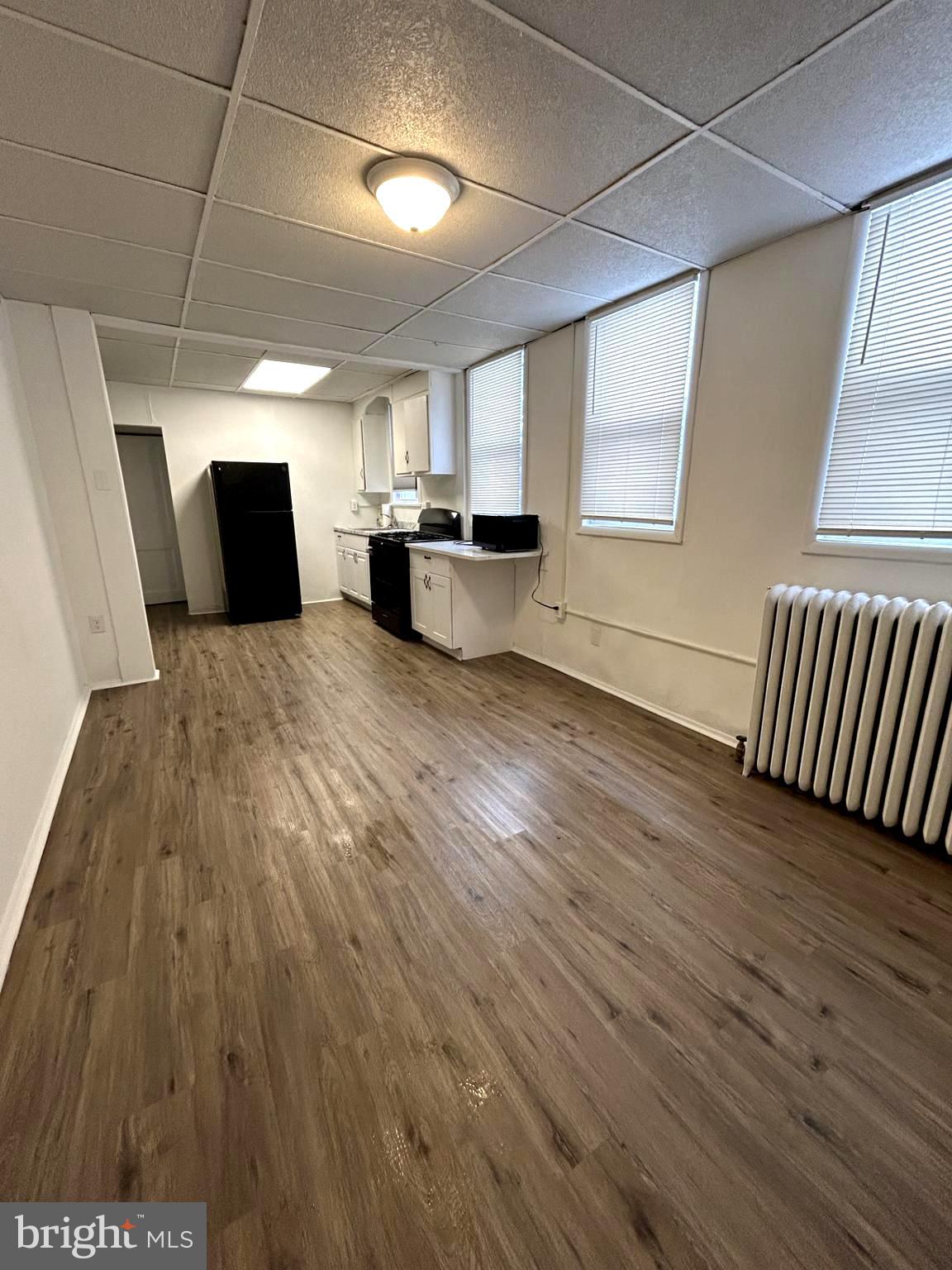 435 Radcliffe Street, Unit 13 Bristol, PA 19007 - Photo 4 of 8 a view of kitchen and wooden floor