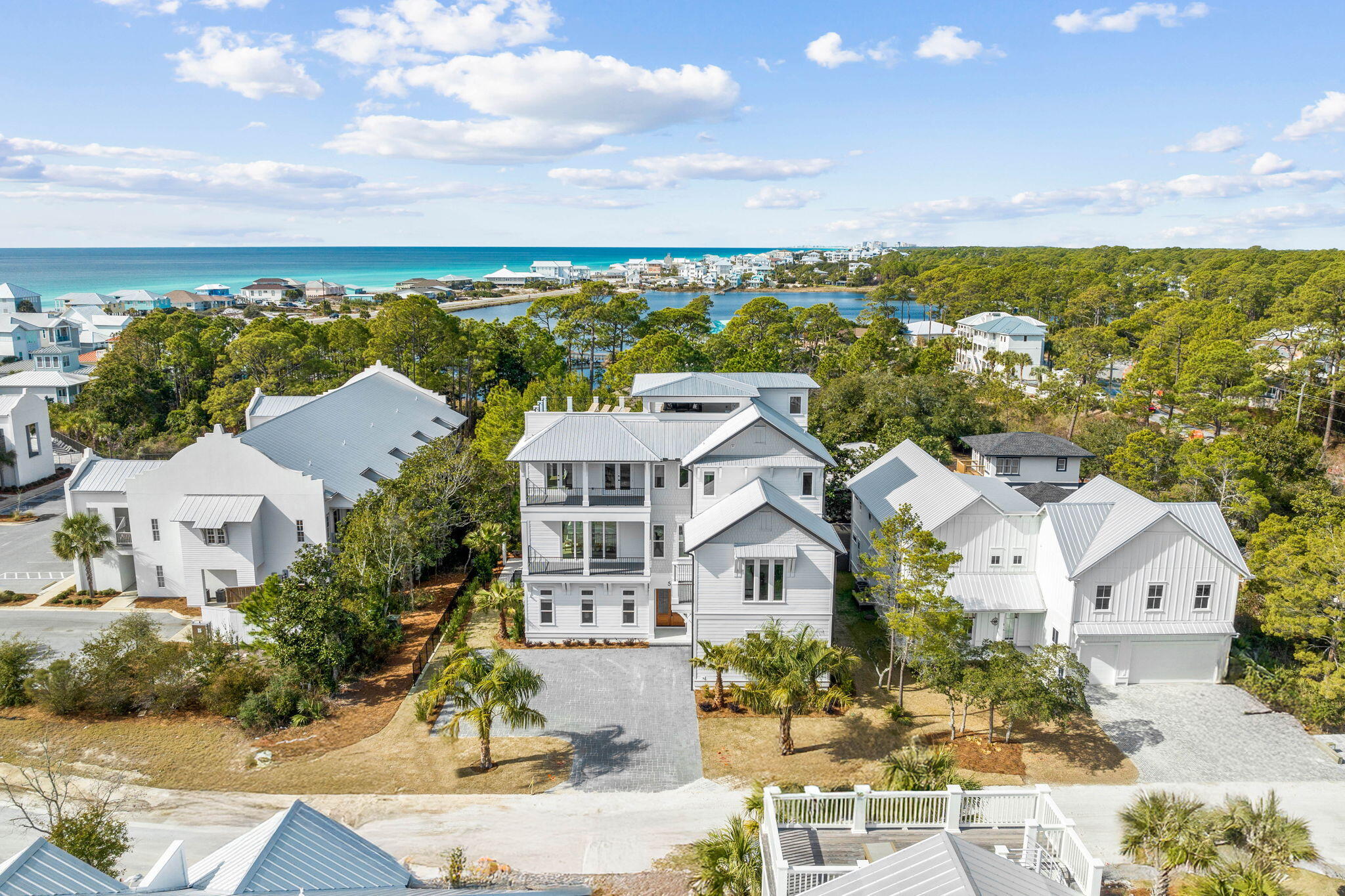 an aerial view of residential houses with outdoor space and street view