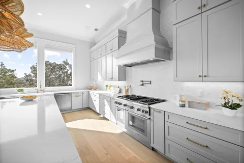 a bathroom with a granite countertop sink and a toilet