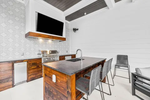 a bathroom with a granite countertop toilet sink and mirror