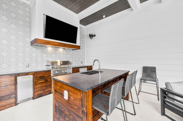 a bathroom with a granite countertop toilet sink and mirror