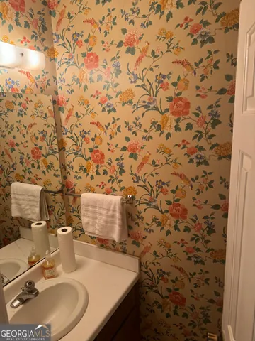 a view of backyard with wooden fence and a bench