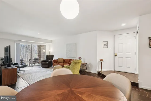 a spacious bedroom with a bed a couch and a large window