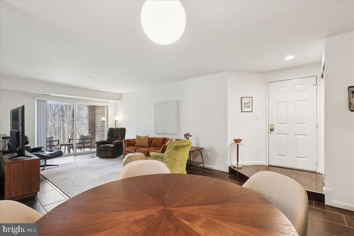 5802 Cove Landing Road, Unit 101 Burke, VA 22015 - Photo 12 of 35 a spacious bedroom with a bed a couch and a large window