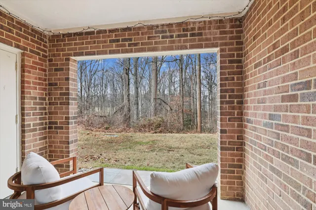 a balcony with chairs and a table