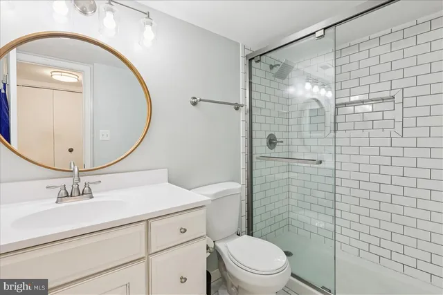 a bathroom with a sink mirror toilet and shower