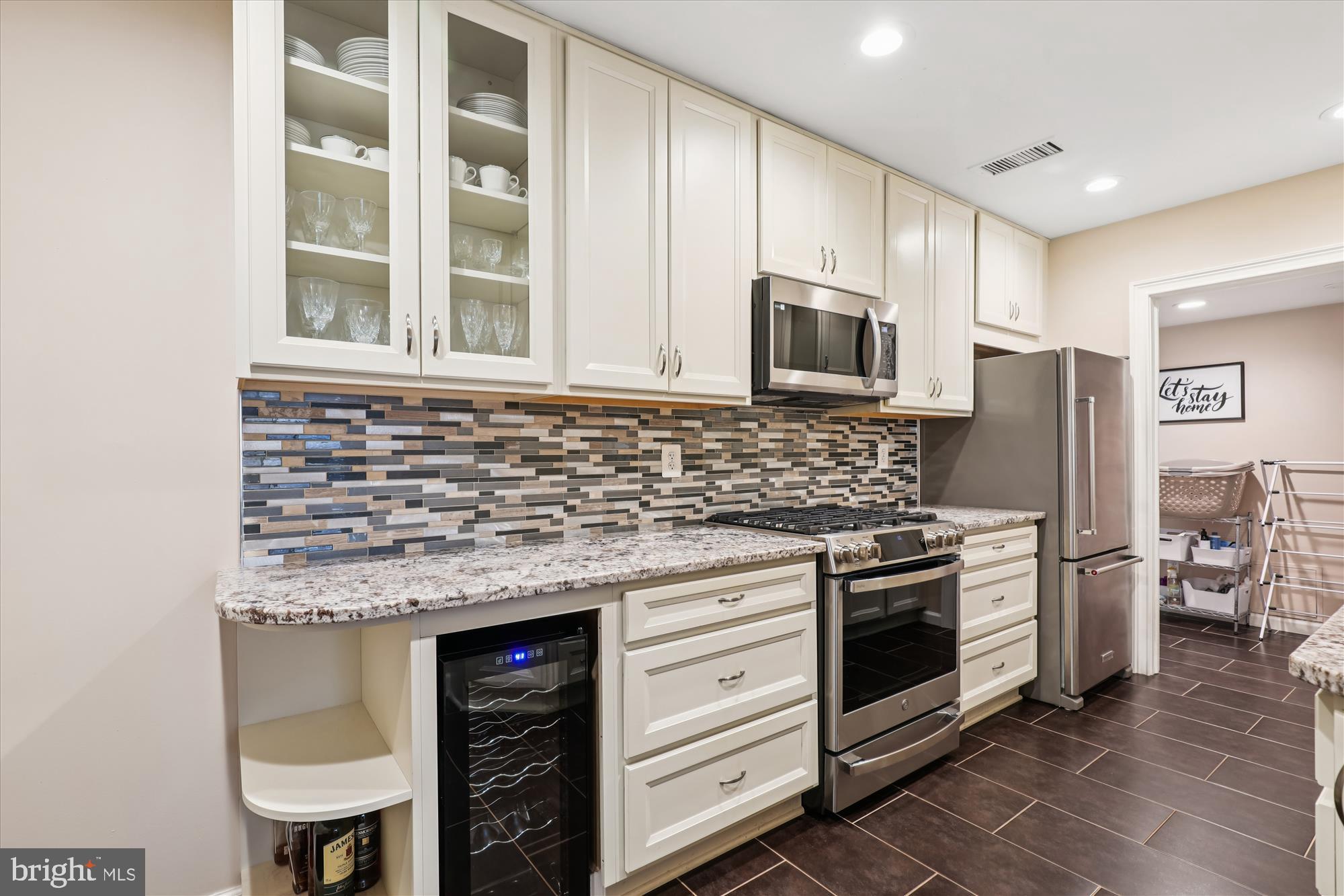 5802 Cove Landing Road, Unit 101 Burke, VA 22015 - Photo 2 of 35 a kitchen with stainless steel appliances granite countertop a stove and a microwave