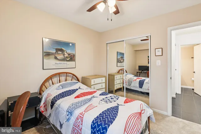 a bedroom with bed and a chandelier