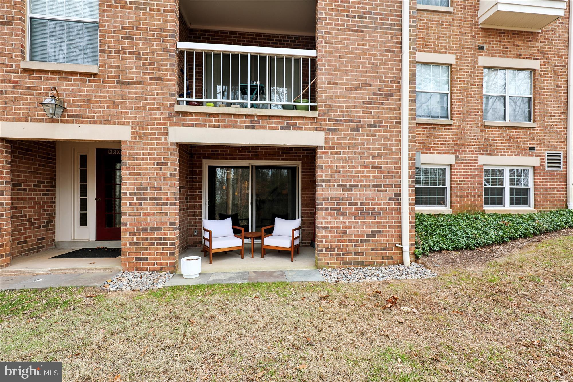 5802 Cove Landing Road, Unit 101 Burke, VA 22015 - Photo 29 of 35 a view of a brick house with many windows