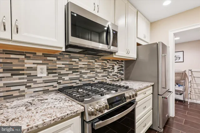 a stove top oven sitting inside of a kitchen