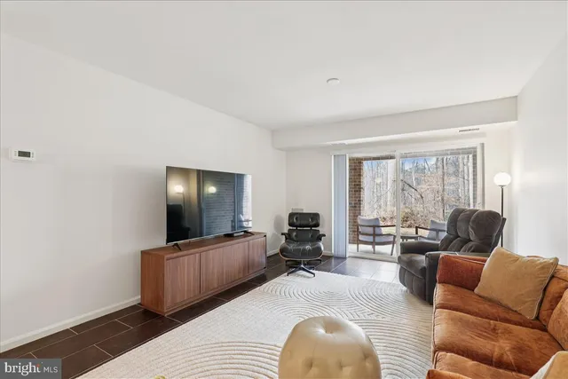 a living room with furniture and large windows