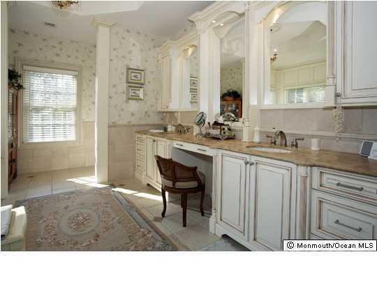 22 Heathcliff Road Rumson, NJ 07760 - Photo 15 of 19 a bathroom with a sink a chair and a large mirror