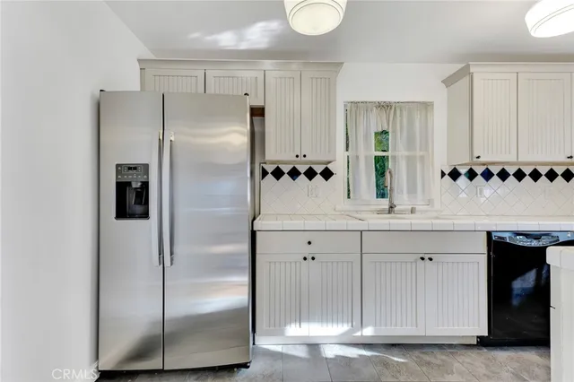 a bathroom with a double vanity sink a two mirror a shower and a glass door