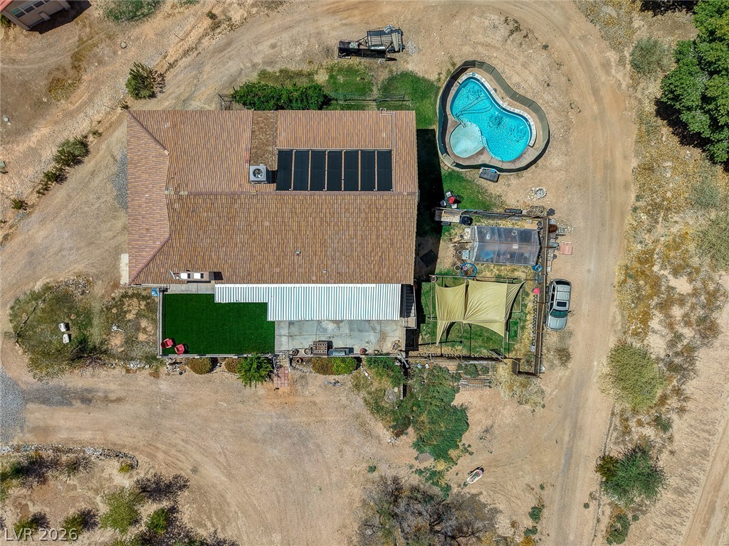 1920 Bowman Road Logandale, NV 89021 - Photo 67 of 68 An aerial perspective showcases the sprawling property footprint featuring a private pool and solar panels.