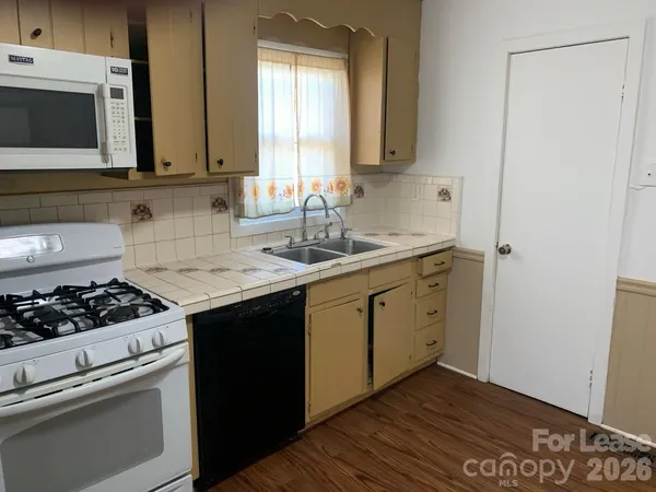 a kitchen with a sink stove and microwave