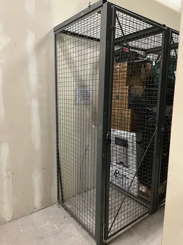 a living room with a couch wooden floor and a dining table